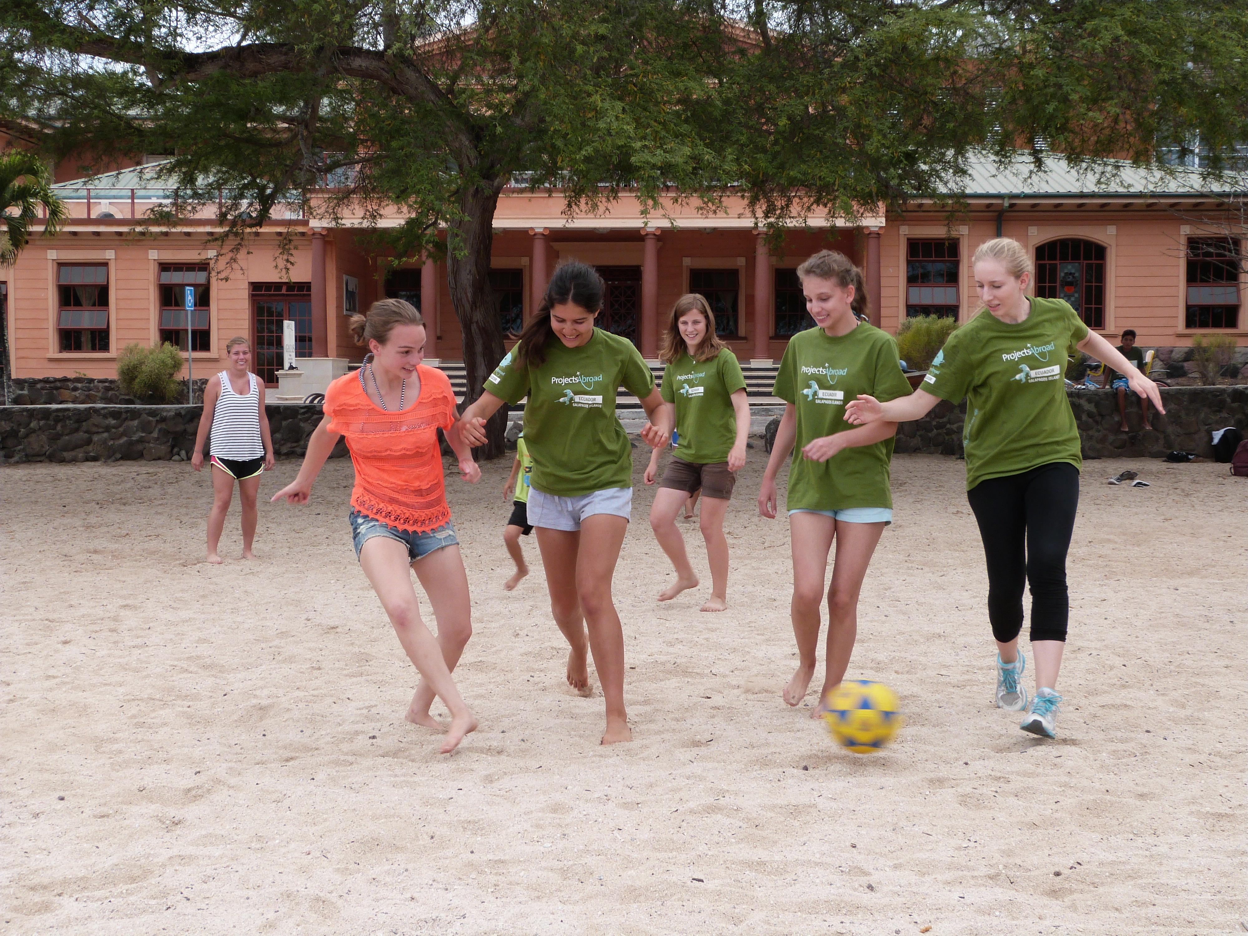Teenagers play football together after a day of volunteer work in Ecuador Volunteers play football and work in the Galapagos during Projects Abroad's programme for high school students